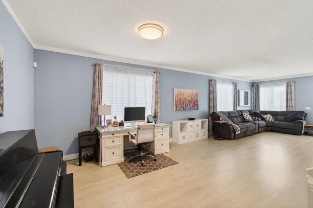 a view of a workspace with a couch and a window