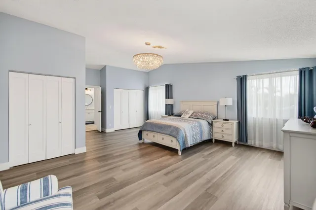 a bedroom with a bed and a chandelier