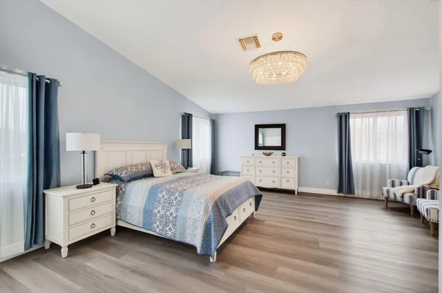 a bedroom with bed and wooden floor