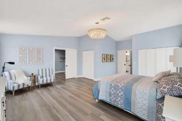 a bedroom with a bed and a chandelier