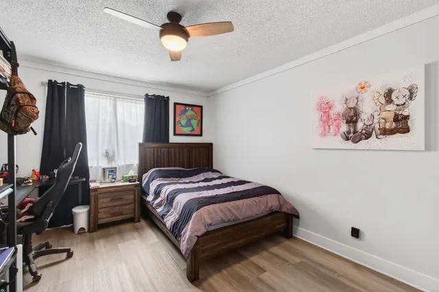 a kitchen with stainless steel appliances a refrigerator a sink a stove and white cabinets