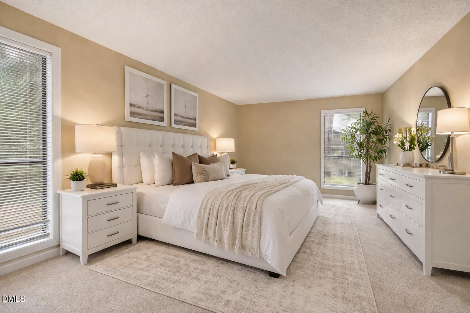 5816 Pointer Drive, Unit 102 Raleigh, NC 27609 - Photo 16 of 25 a bedroom with a bed and a lamp on dresser