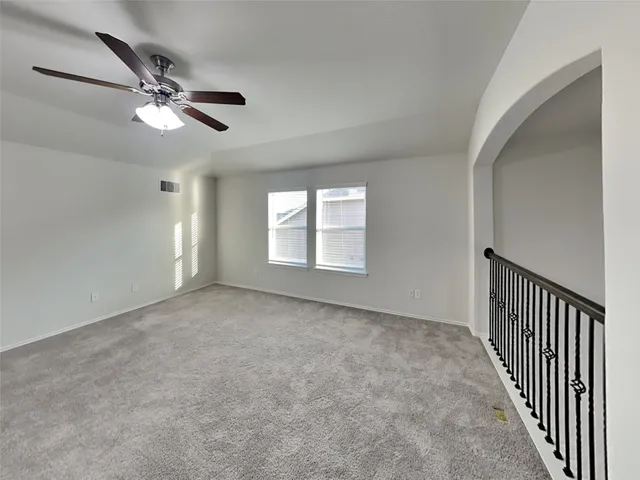 a view of a livingroom with a ceiling fan and window