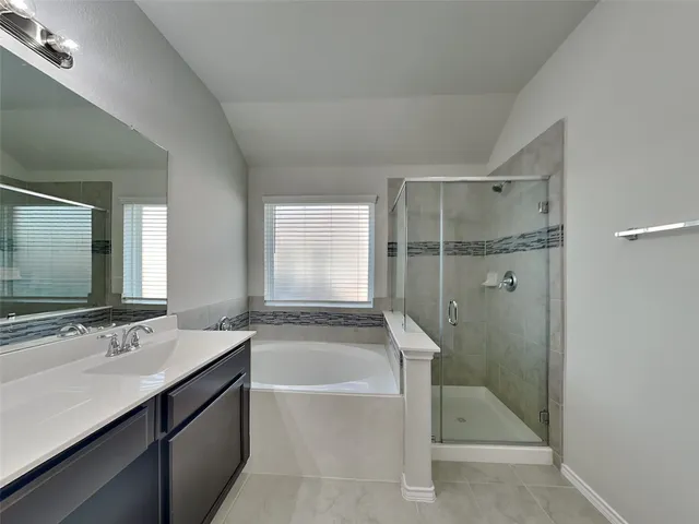 a bathroom with a bathtub and a sink