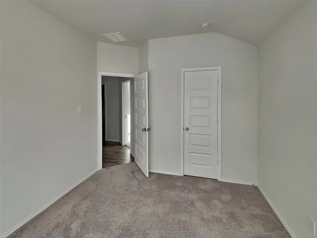 an empty room with closet area