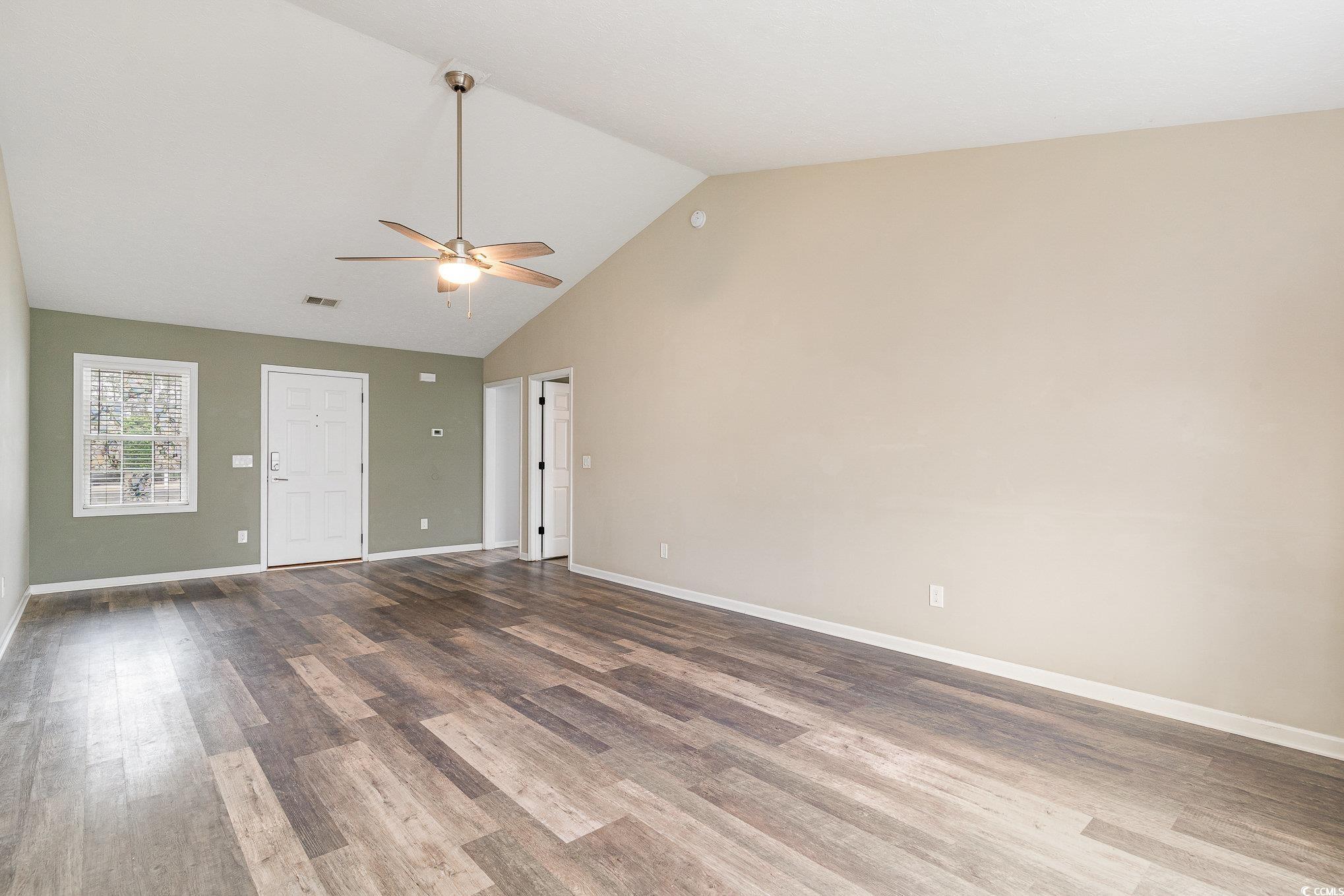 9545 Sullivan Drive Murrells Inlet, SC 29576 - Photo 13 of 30 Spare room featuring dark wood-type flooring, ceil