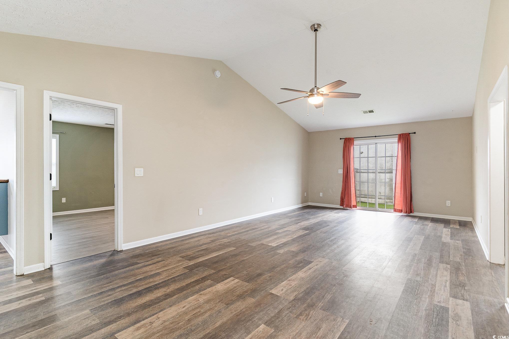 9545 Sullivan Drive Murrells Inlet, SC 29576 - Photo 14 of 30 Empty room featuring ceiling fan, lofted ceiling,