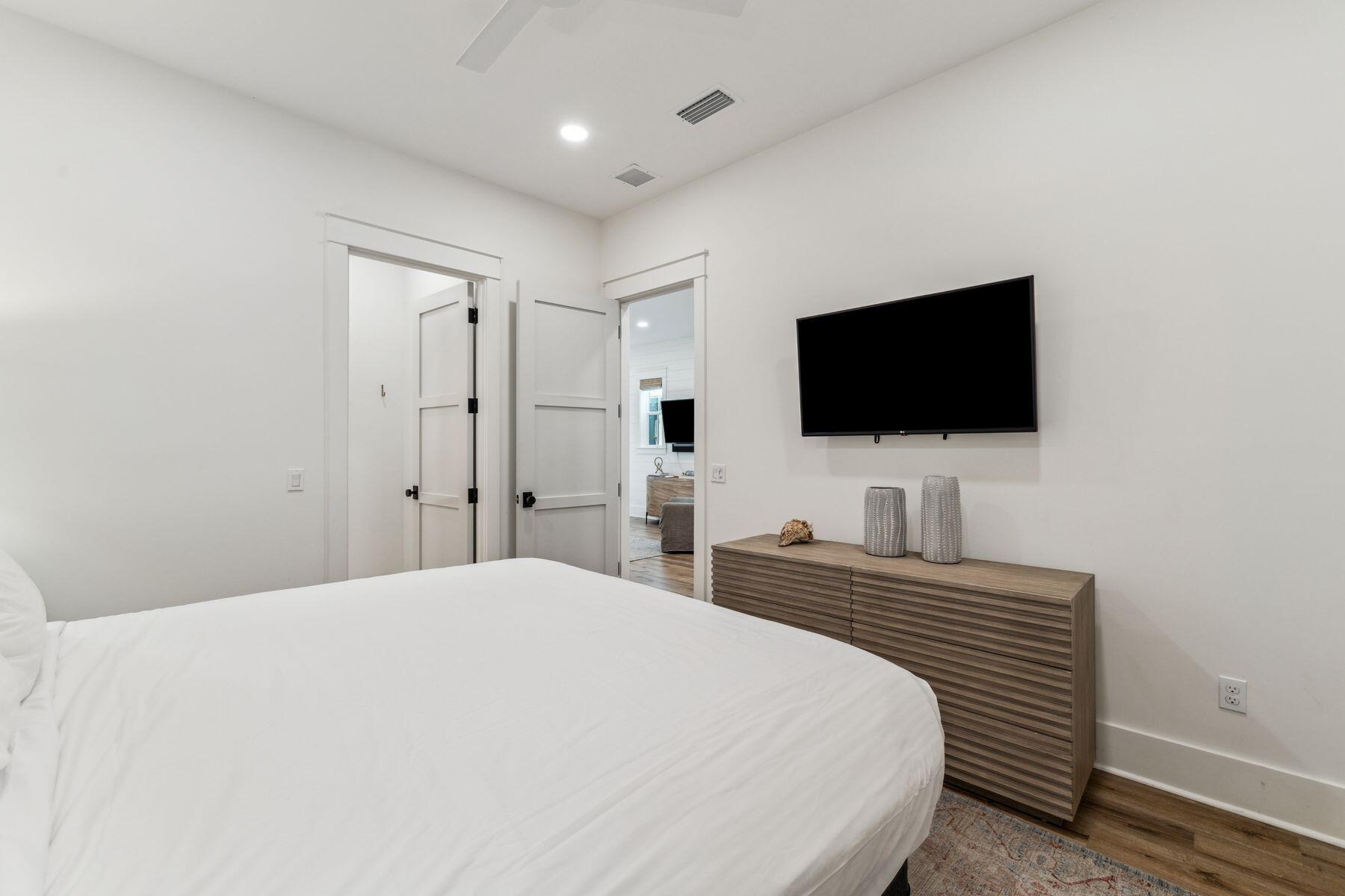 207 Anchor Rode Circle Santa Rosa Beach, FL 32459 - Photo 19 of 44 a bedroom with a bed and a flat screen tv