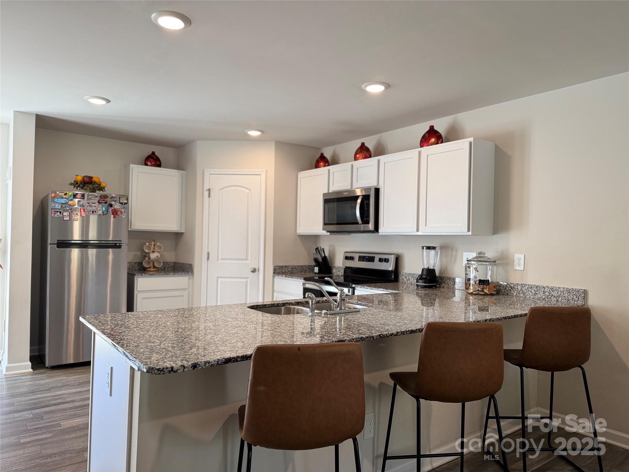 327 J C Dellinger Road Cherryville, NC 28021 - Photo 11 of 30 a kitchen with stainless steel appliances granite countertop a stove top oven a sink and a refrigerator
