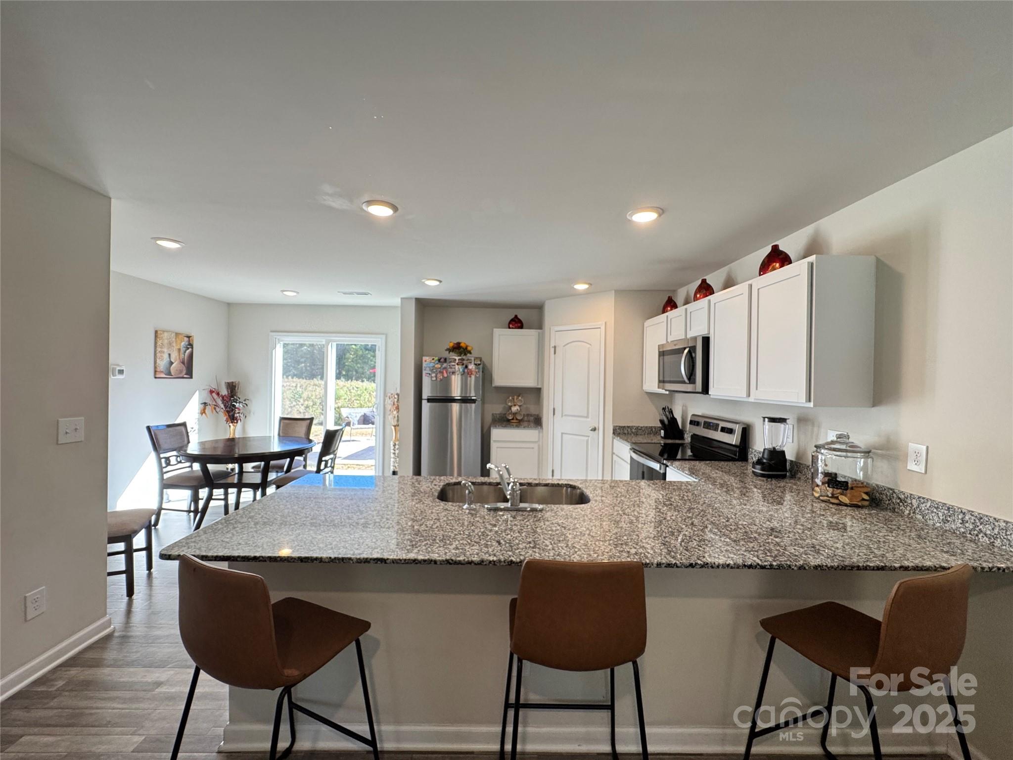 327 J C Dellinger Road Cherryville, NC 28021 - Photo 12 of 30 a kitchen with granite countertop kitchen island stainless steel appliances a table and chairs