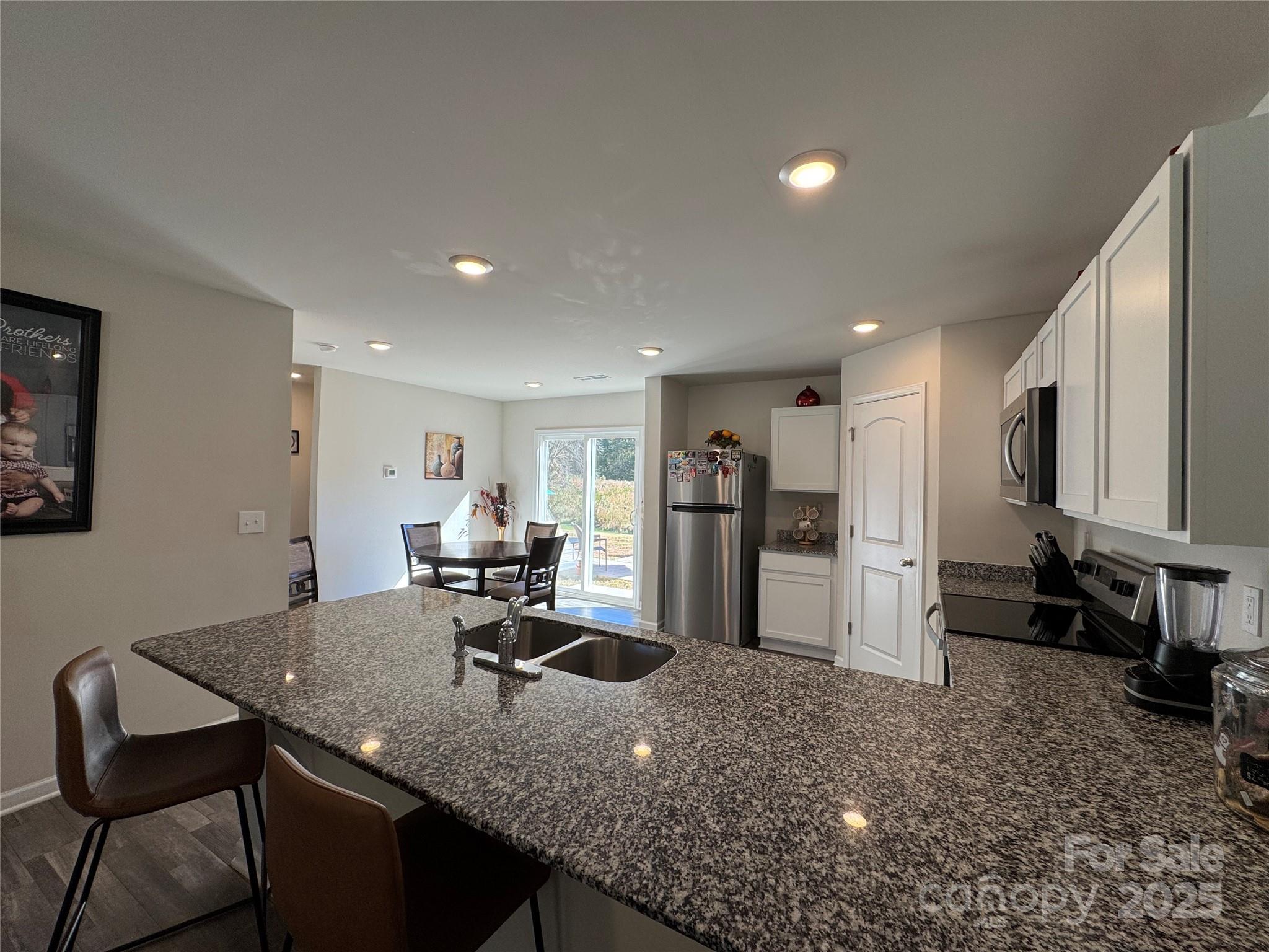 327 J C Dellinger Road Cherryville, NC 28021 - Photo 13 of 30 a view of a kitchen with refrigerator and chairs