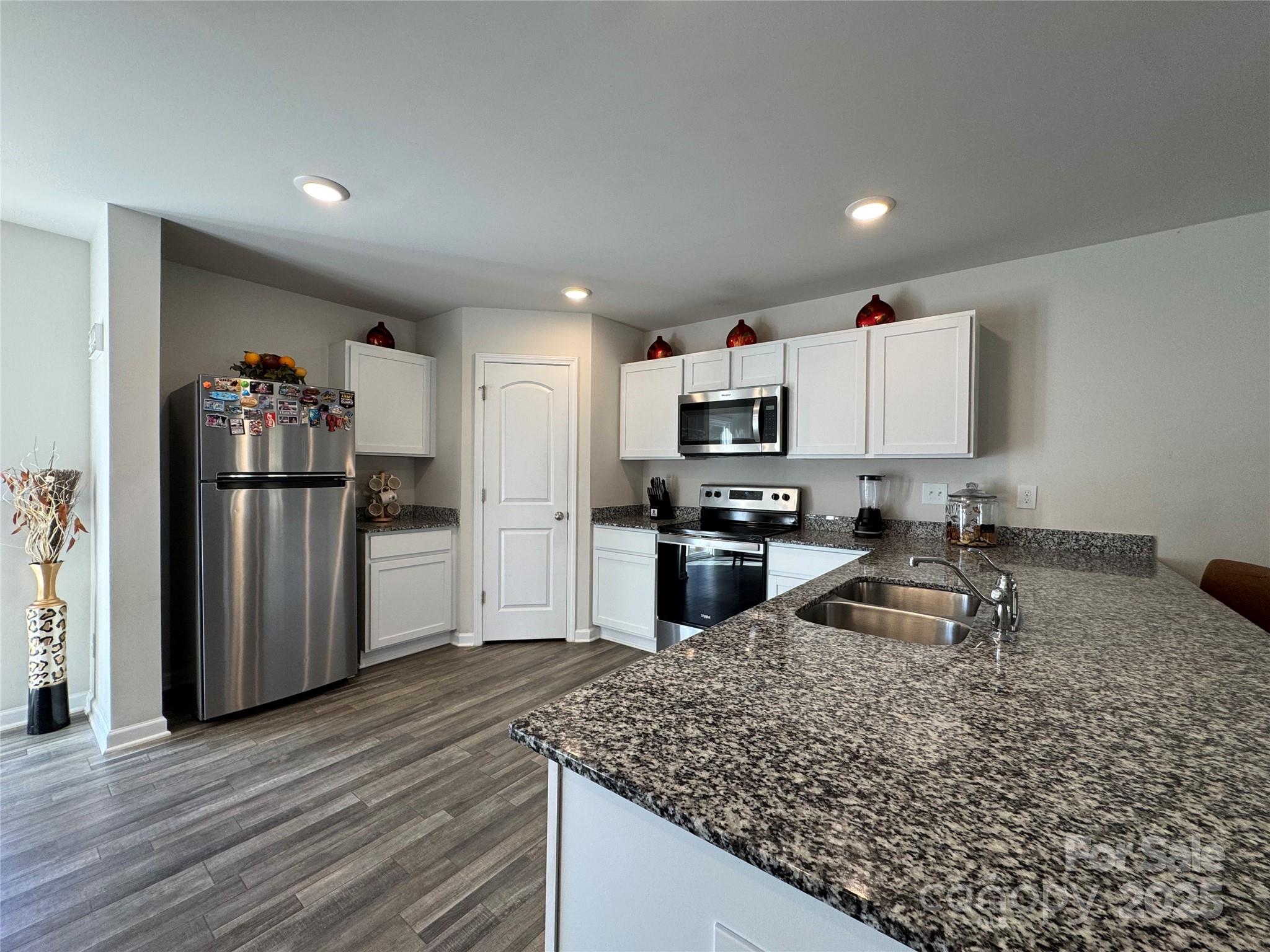 327 J C Dellinger Road Cherryville, NC 28021 - Photo 14 of 30 a kitchen with granite countertop a refrigerator and a sink