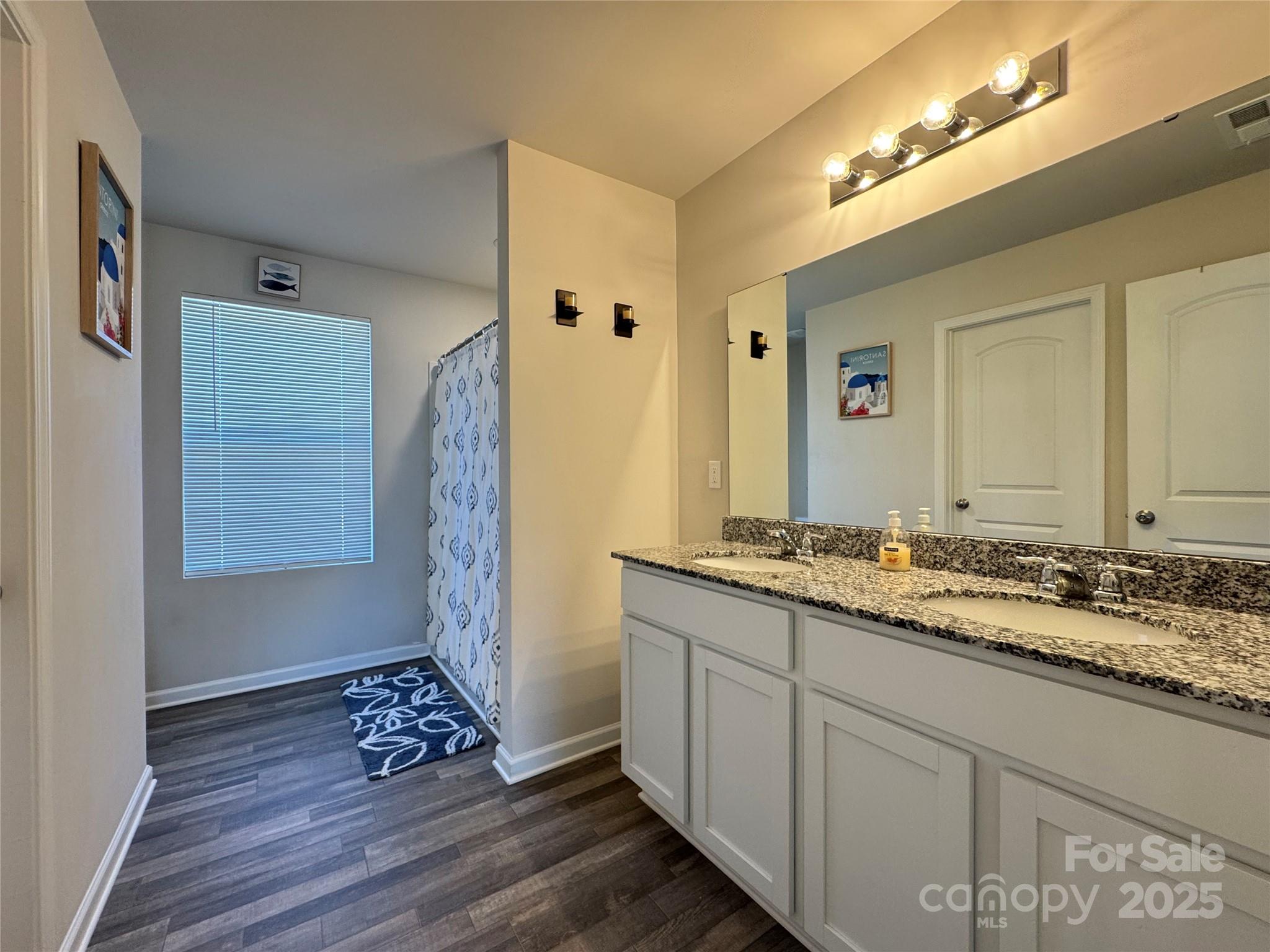 327 J C Dellinger Road Cherryville, NC 28021 - Photo 21 of 30 a spacious bathroom with a granite countertop sink and a mirror