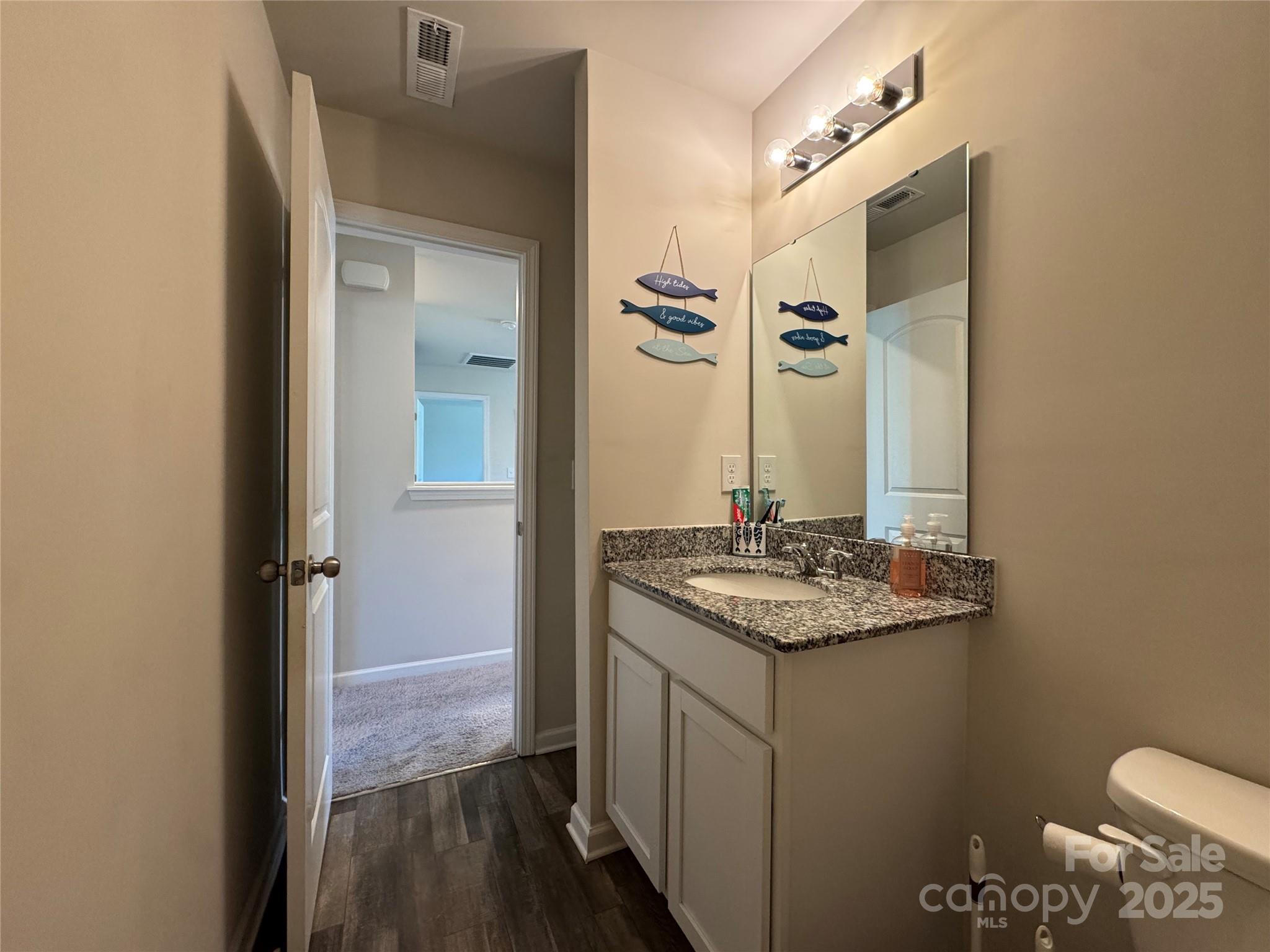 327 J C Dellinger Road Cherryville, NC 28021 - Photo 24 of 30 a bathroom with a granite countertop sink toilet and mirror