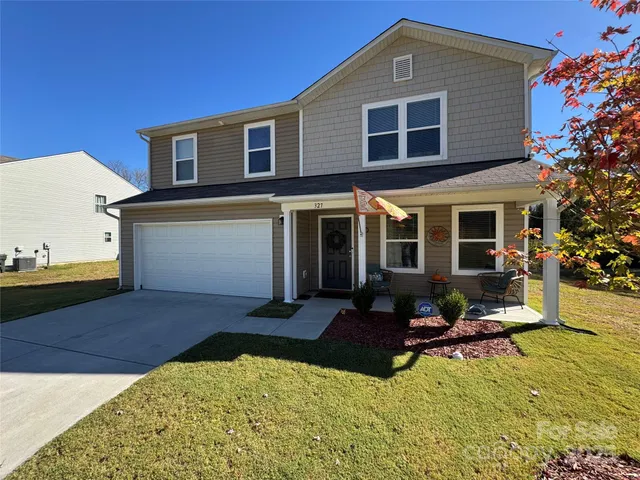 a front view of a house with yard and balcony