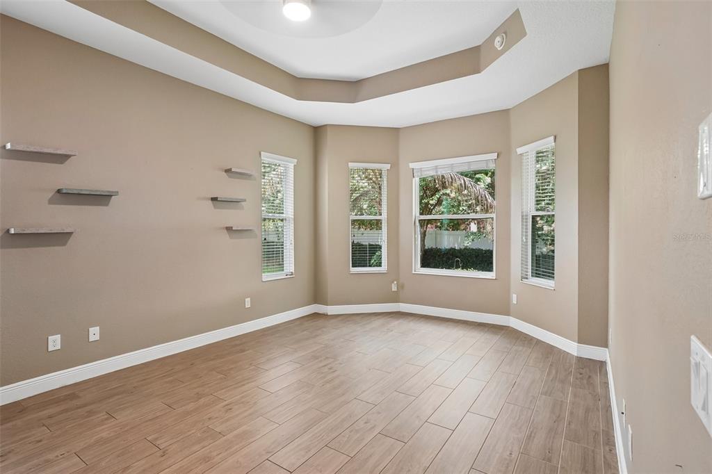 10339 Addison Shore Way Oxford, FL 34484 - Photo 38 of 54 a view of an empty room with wooden floor and a window