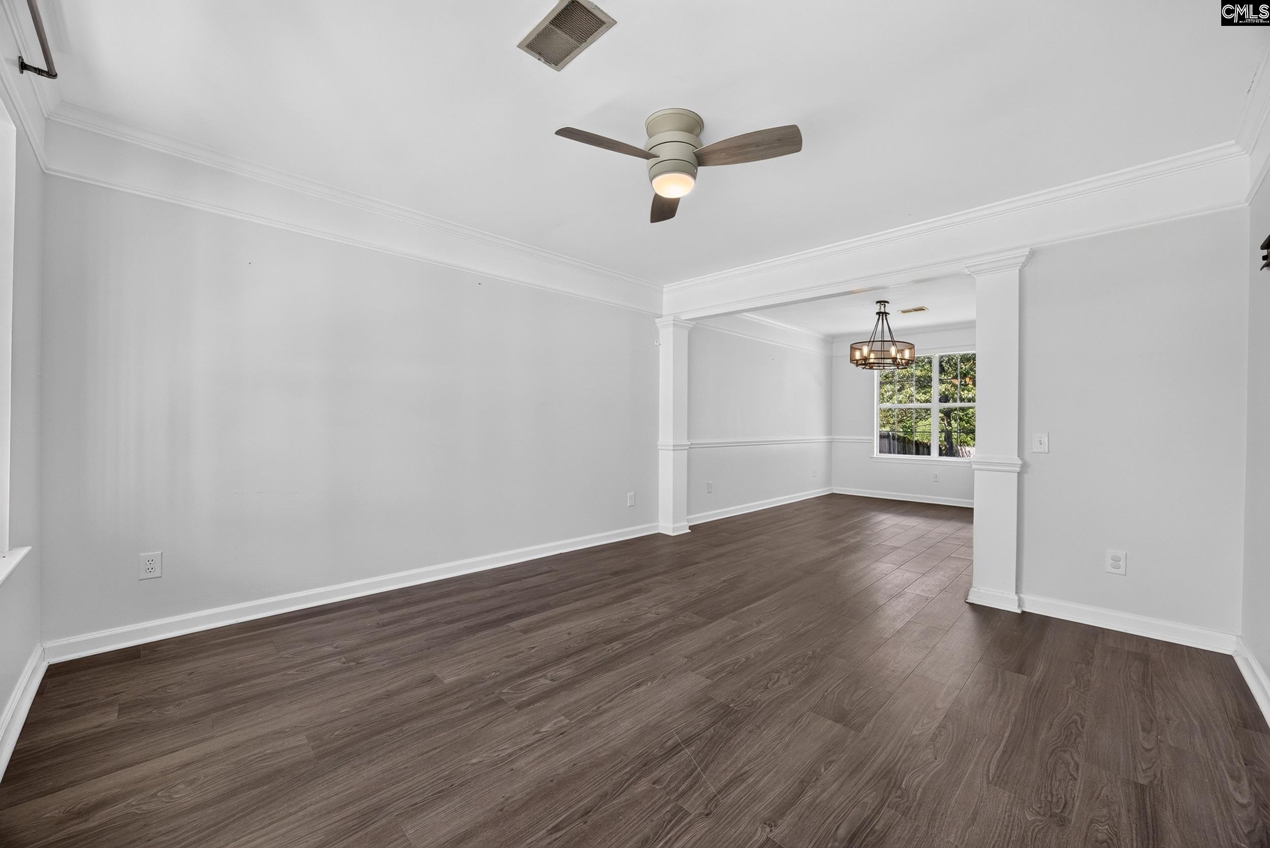 407 Sesqui Trail Columbia, SC 29223 - Photo 8 of 34 an empty room with wooden floor fan and windows