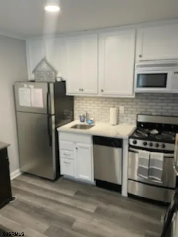 a kitchen with a stove microwave and refrigerator
