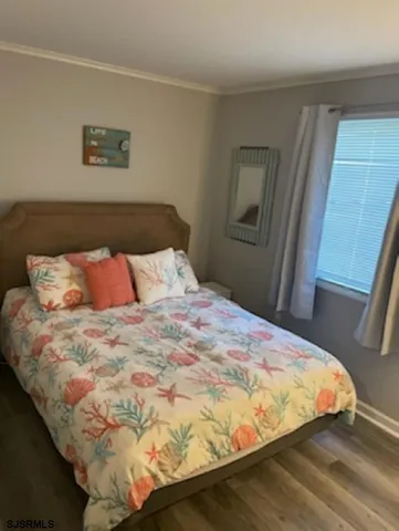 a bedroom with a bed and painting on the wall