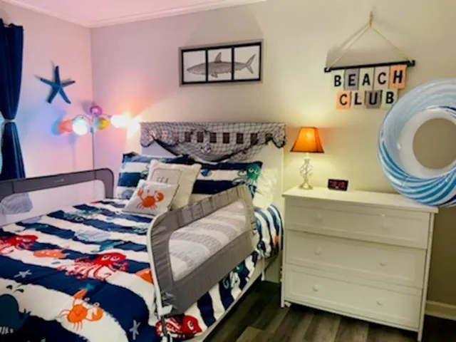 a bedroom with bed and a chandelier