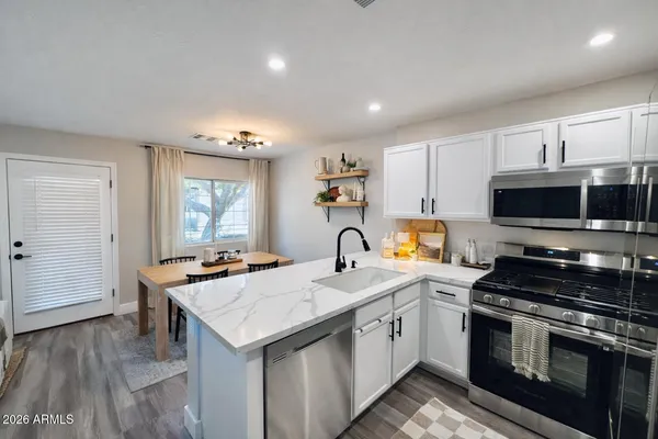 a kitchen with a stove a sink and a refrigerator