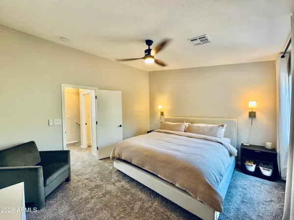 a bedroom with a bed and a chandelier