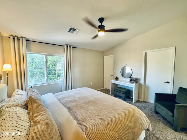 a bedroom with a large bed and a large window