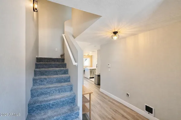 a view of entryway and hall with wooden floor