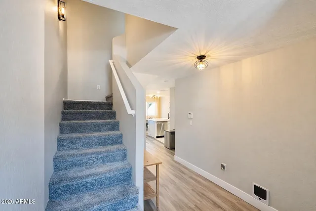 a view of entryway and hall with wooden floor