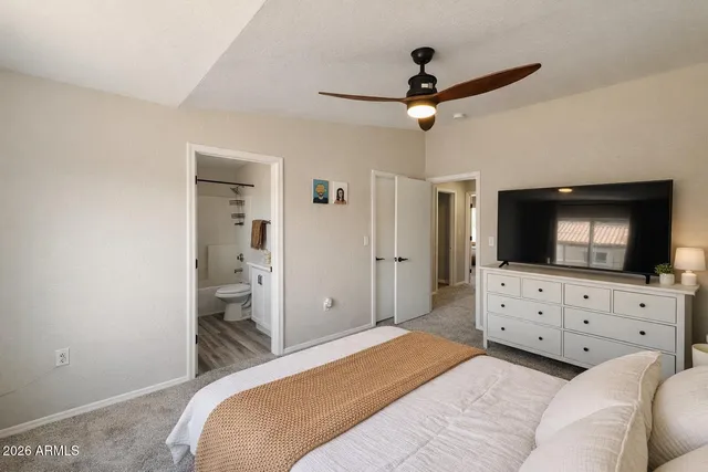 a bedroom with a bed and a flat screen tv