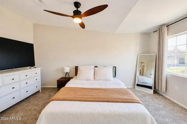 a bedroom with a bed and a flat screen tv