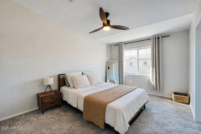 a bed room with a bed and a window