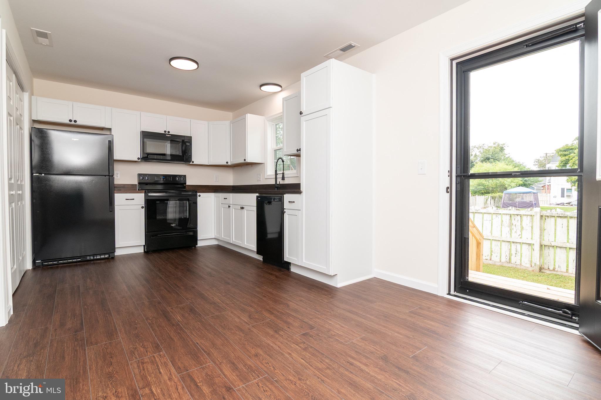 105 East Adams Street Georgetown, DE 19947 - Photo 11 of 49 a kitchen with stainless steel appliances granite countertop a refrigerator and a stove top oven