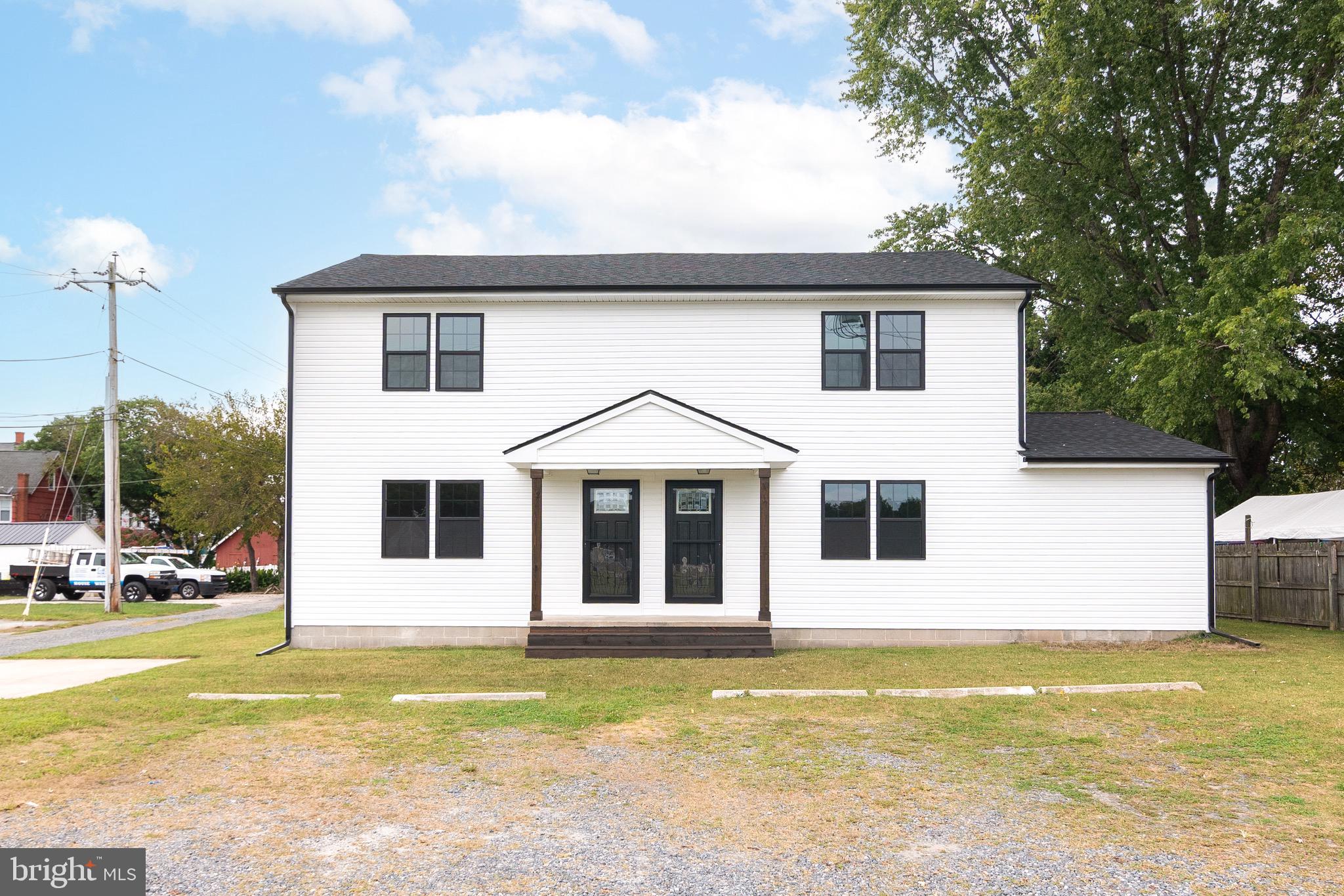 105 East Adams Street Georgetown, DE 19947 - Photo 2 of 49 a view of a house with a swimming pool
