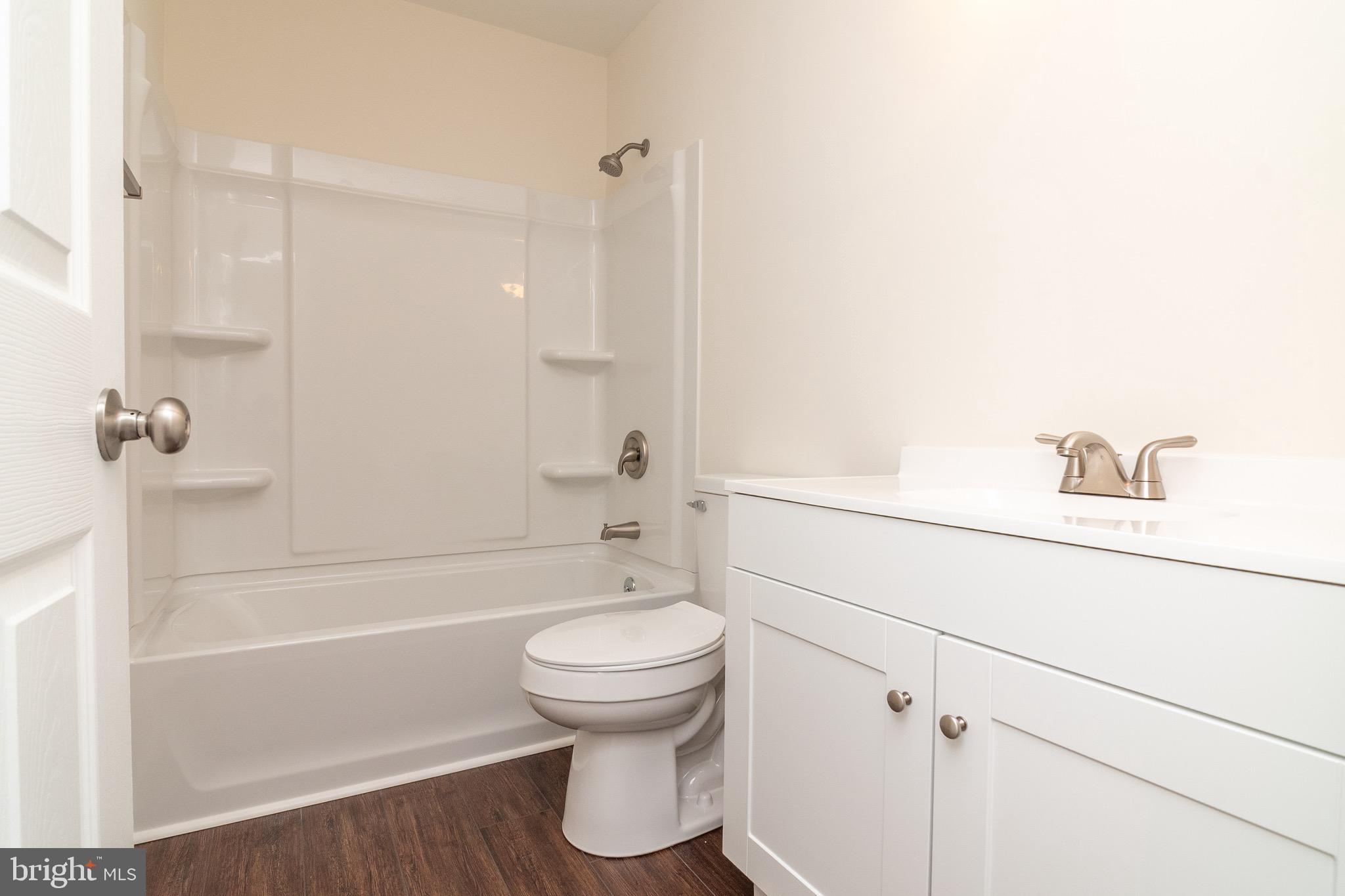 105 East Adams Street Georgetown, DE 19947 - Photo 23 of 49 a bathroom with a shower and a toilet