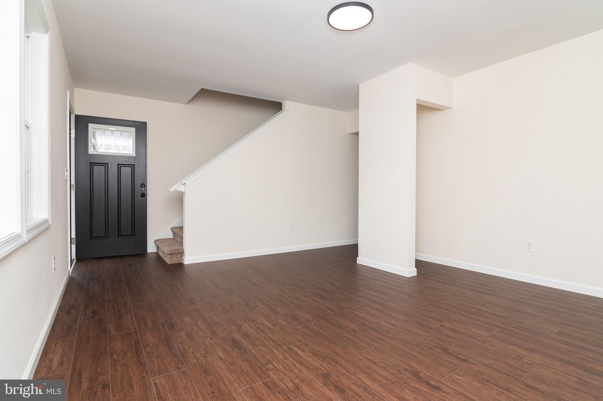 105 East Adams Street Georgetown, DE 19947 - Photo 27 of 49 a view of an empty room with wooden floor and closet