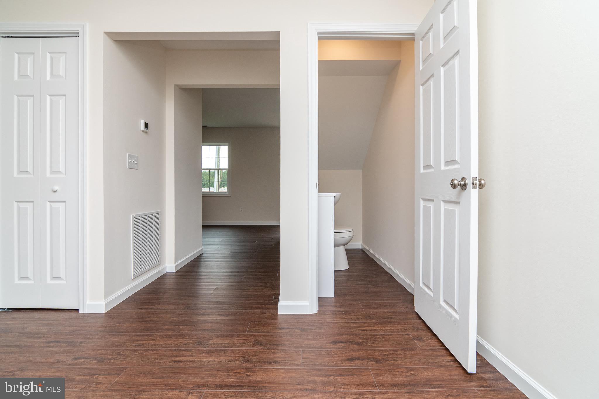 105 East Adams Street Georgetown, DE 19947 - Photo 33 of 49 a view of a hallway with wooden floor