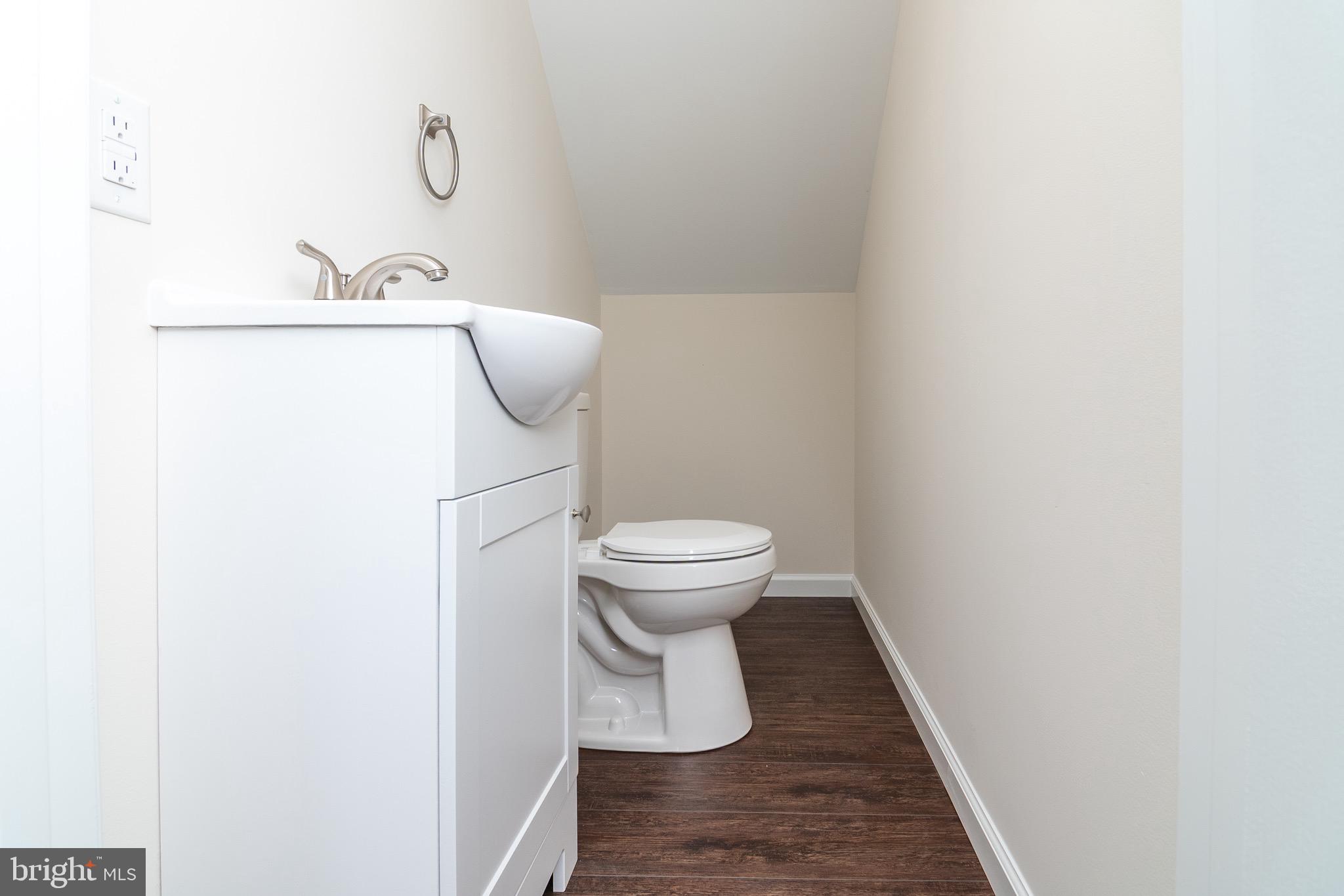105 East Adams Street Georgetown, DE 19947 - Photo 34 of 49 a bathroom with a toilet and a mirror