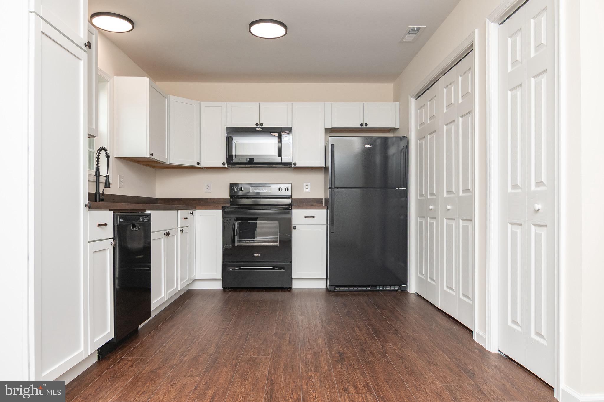 105 East Adams Street Georgetown, DE 19947 - Photo 37 of 49 a kitchen with stainless steel appliances a refrigerator and a stove