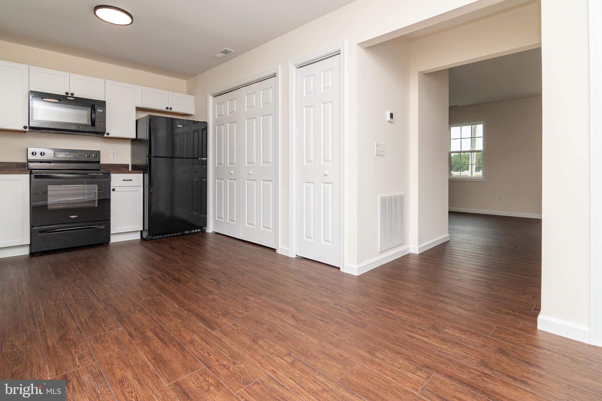 105 East Adams Street Georgetown, DE 19947 - Photo 38 of 49 a kitchen with stainless steel appliances a refrigerator and a stove top oven