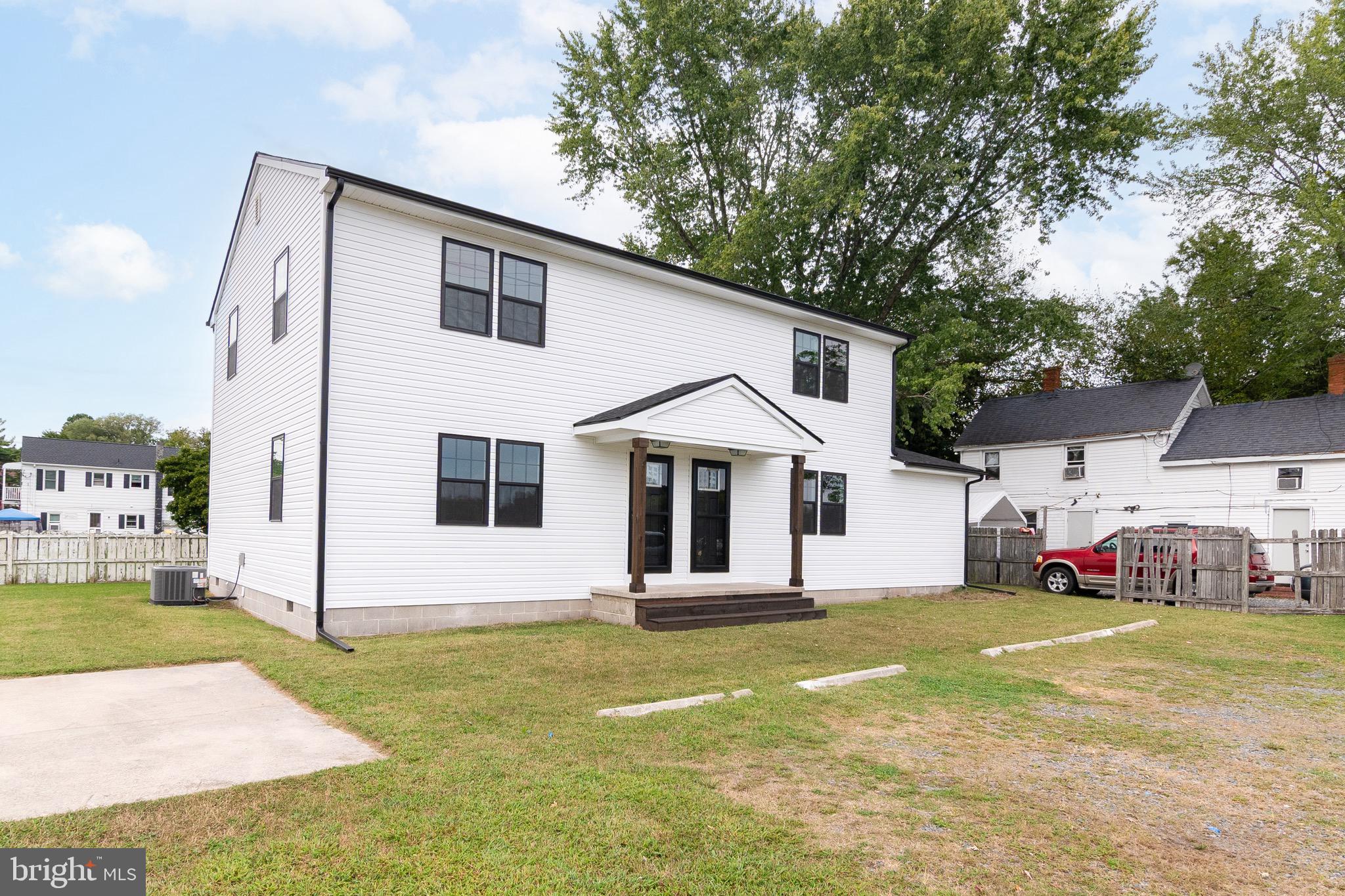 105 East Adams Street Georgetown, DE 19947 - Photo 4 of 49 a front view of a house with a yard