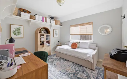 a bedroom with bed and a window