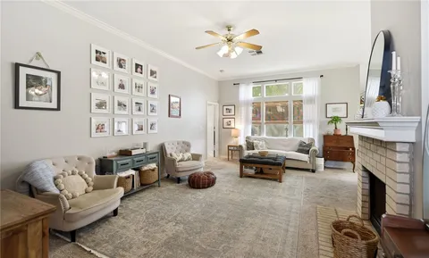 a living room with furniture fireplace and a large window