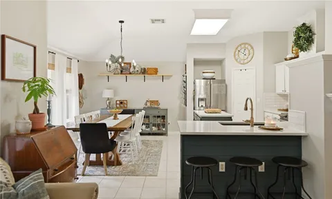 a view of a dining room with furniture and a chandelier