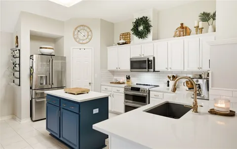 a kitchen with a sink a stove and refrigerator
