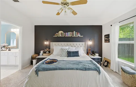 a bedroom with a bed and glass windows