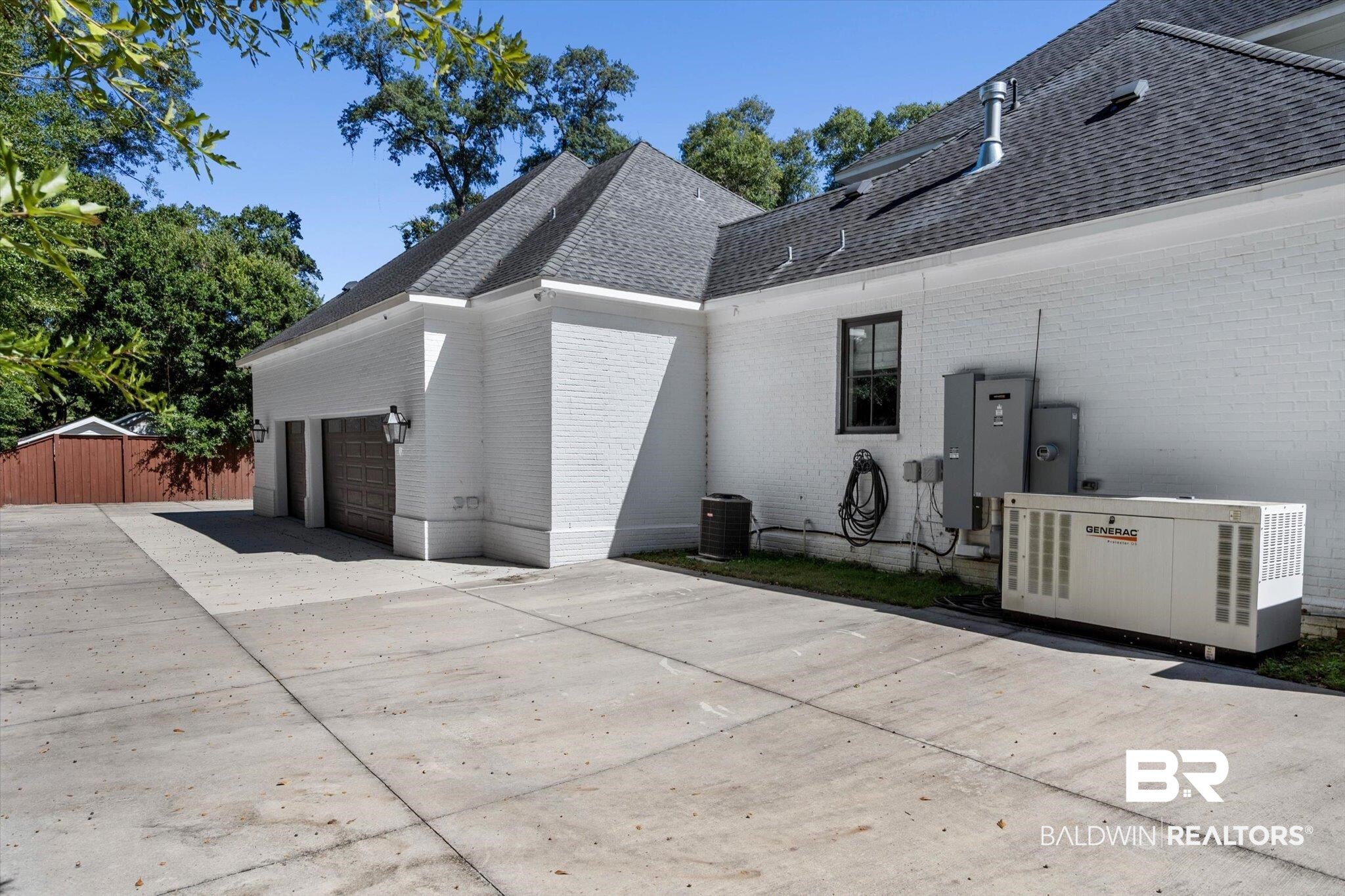 4602 Kingswood Drive Mobile, AL 36608 - Photo 40 of 45 View of home's exterior with brick siding, concrete driveway, a shingled roof, and an attached garage