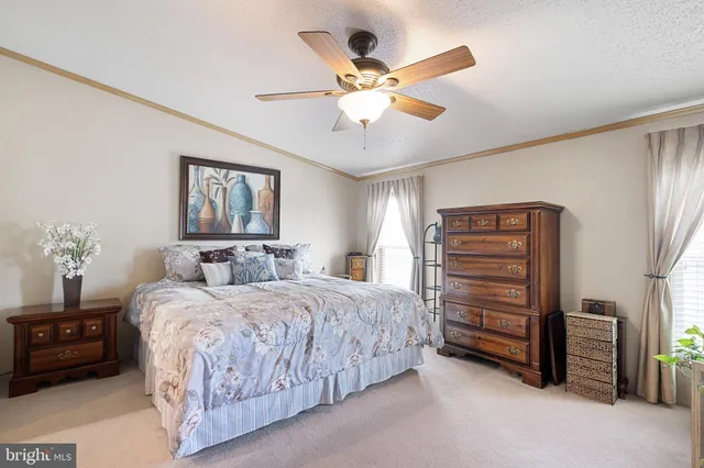 a bedroom with a bed chandelier and a window