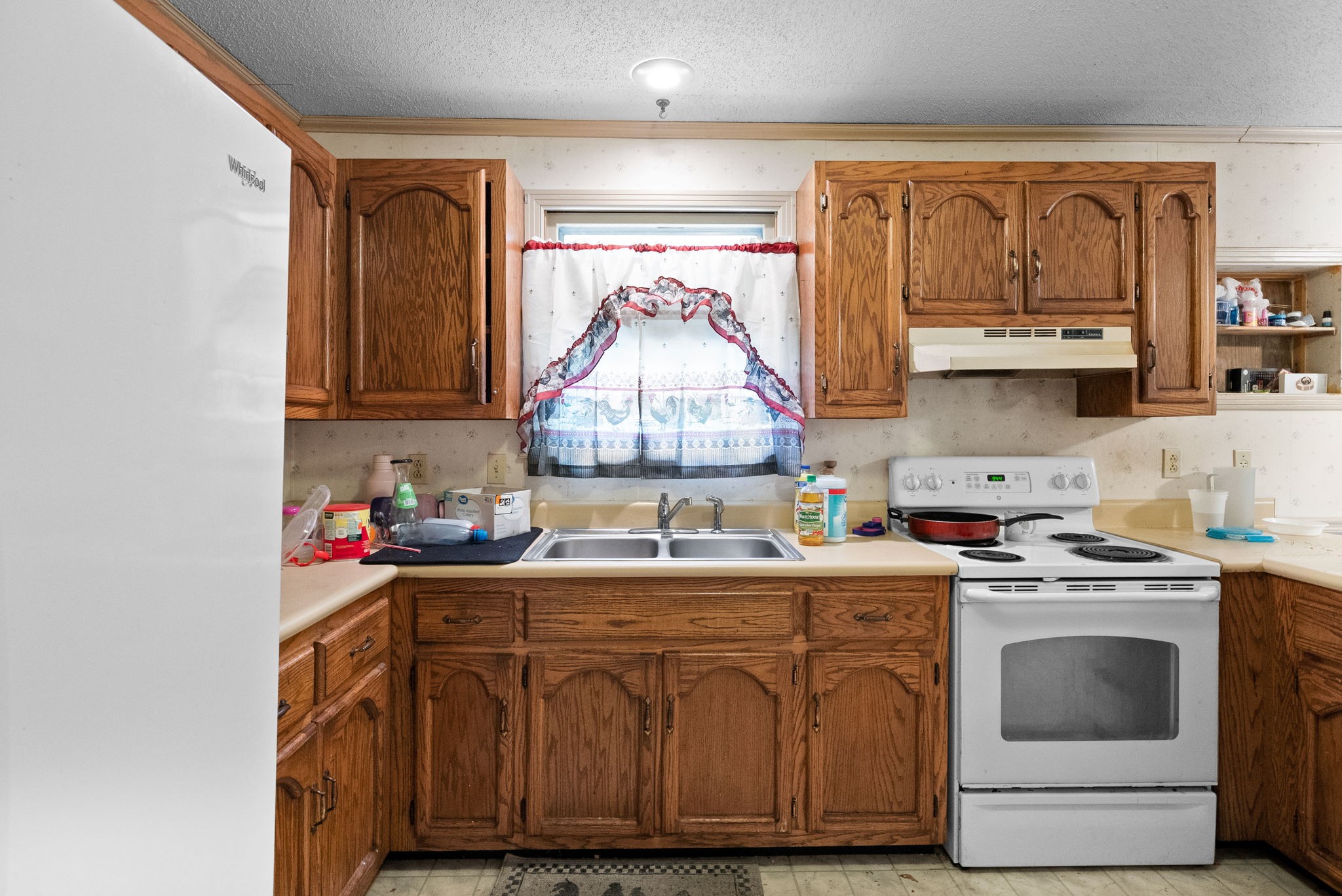 511 Ruby Drive Clarksville, TN 37040 - Photo 10 of 25 a kitchen with kitchen island granite countertop a sink cabinets stainless steel appliances and a window