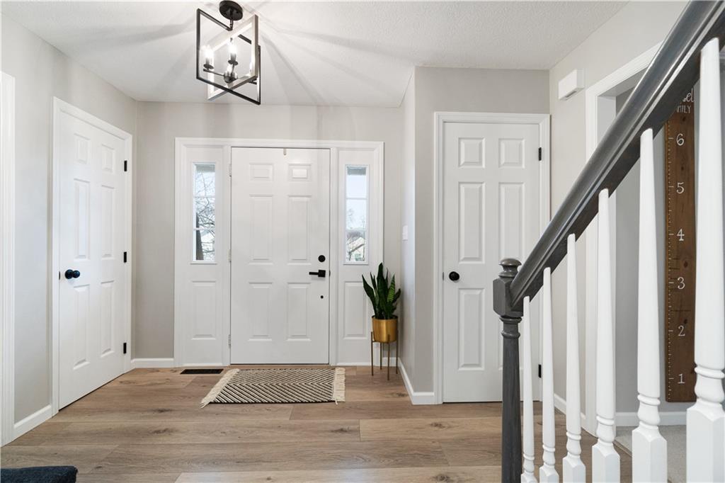 528 Pine Bluff Drive Mars, PA 16046 - Photo 2 of 25 a view of a hallway with wooden floor and staircase
